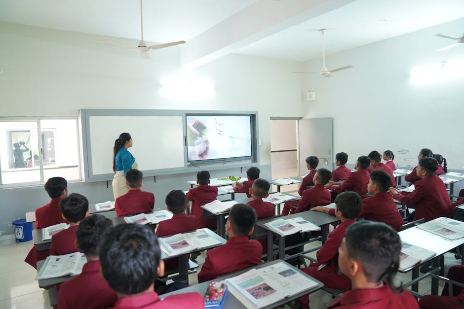 Students attentively learning in a modern classroom with an interactive display at Petlad, Gujarat.
